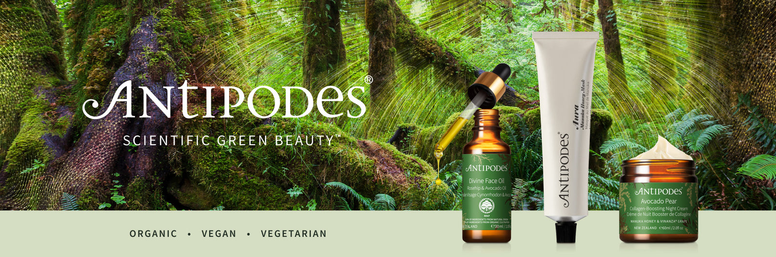 A promotional banner for Antipodes Scientific Green Beauty, featuring several skincare products including an amber bottle, a white tube, and a green jar, set against a lush green forest background with the brand name 'Antipodes' prominently displayed.