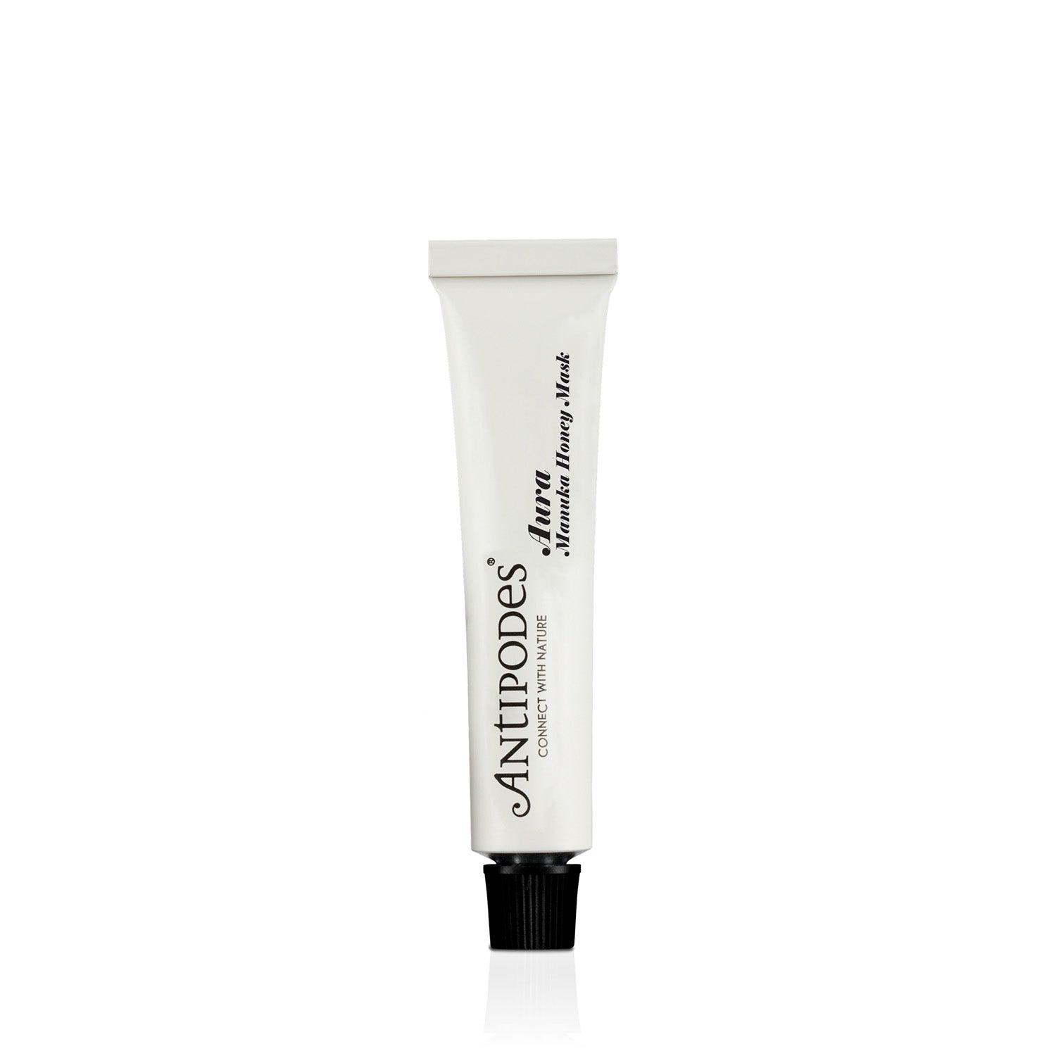 A white squeeze tube of Antipodes Aura Manuka Honey mini Mask with a black cap, centered on a plain white background.