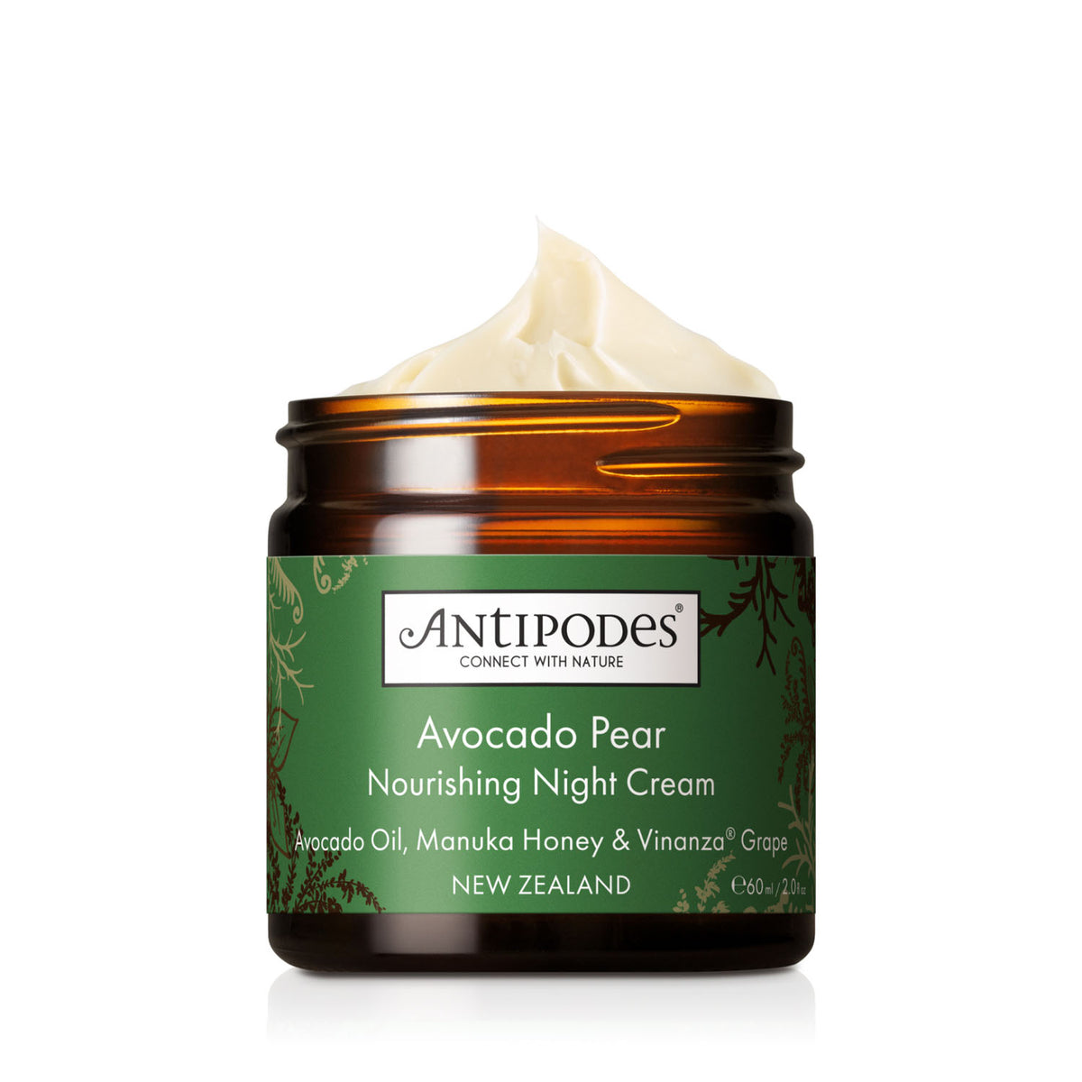 An amber glass jar of Antipodes Avocado Pear Nourishing Night Cream with a green label and a swirl of cream visible at the top, set against a clean white background.