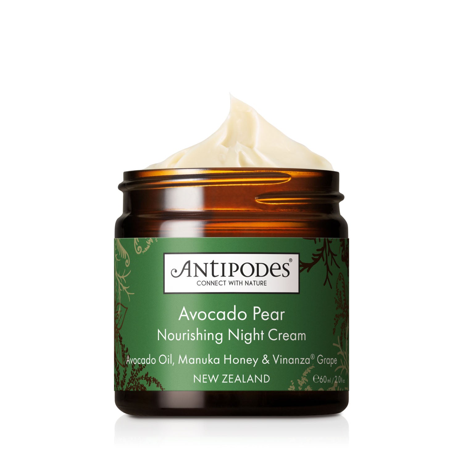 An amber glass jar of Antipodes Avocado Pear Nourishing Night Cream with a green label and a swirl of cream visible at the top, set against a clean white background.